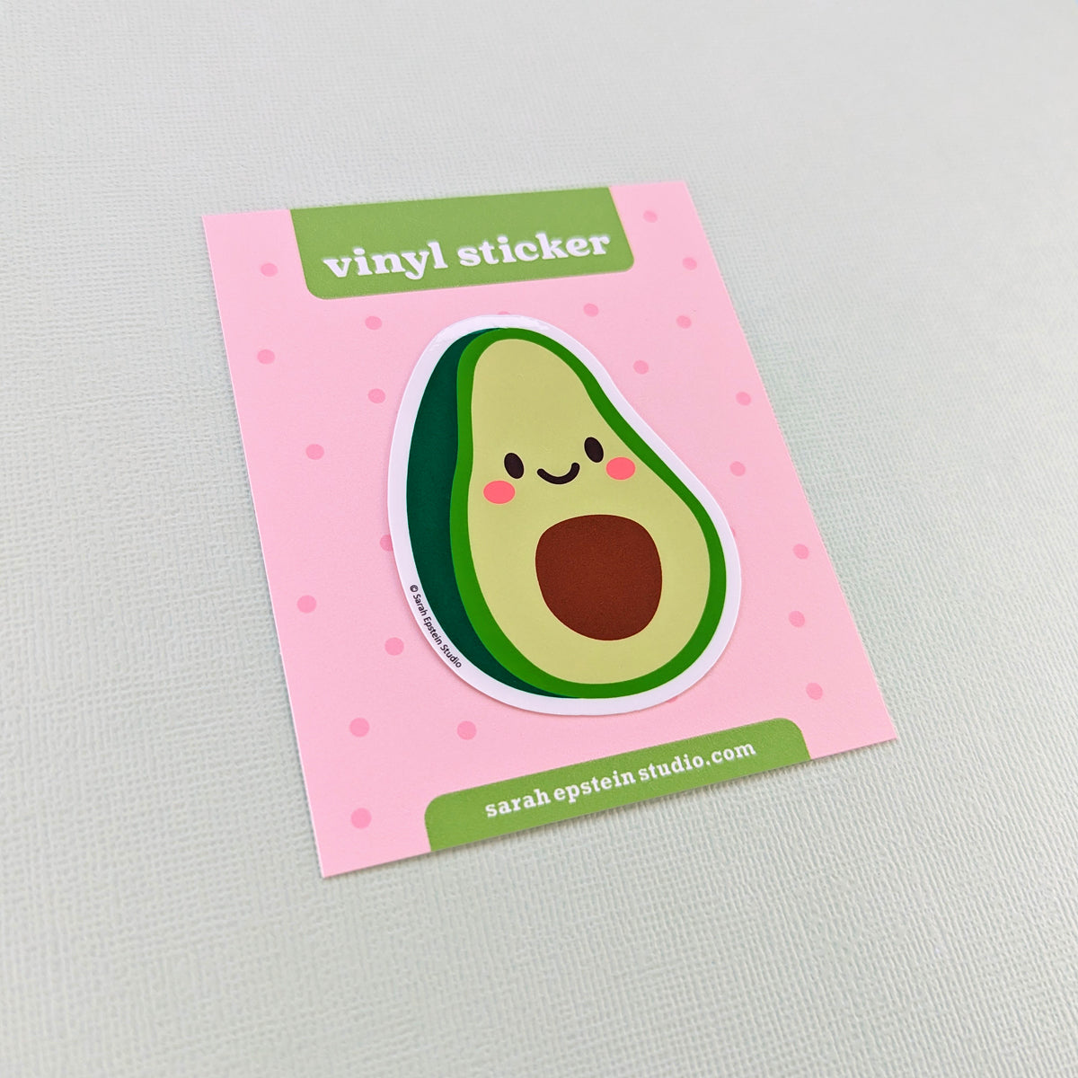 Kawaii avocado die-cut vinyl sticker by Sarah Epstein Studio.