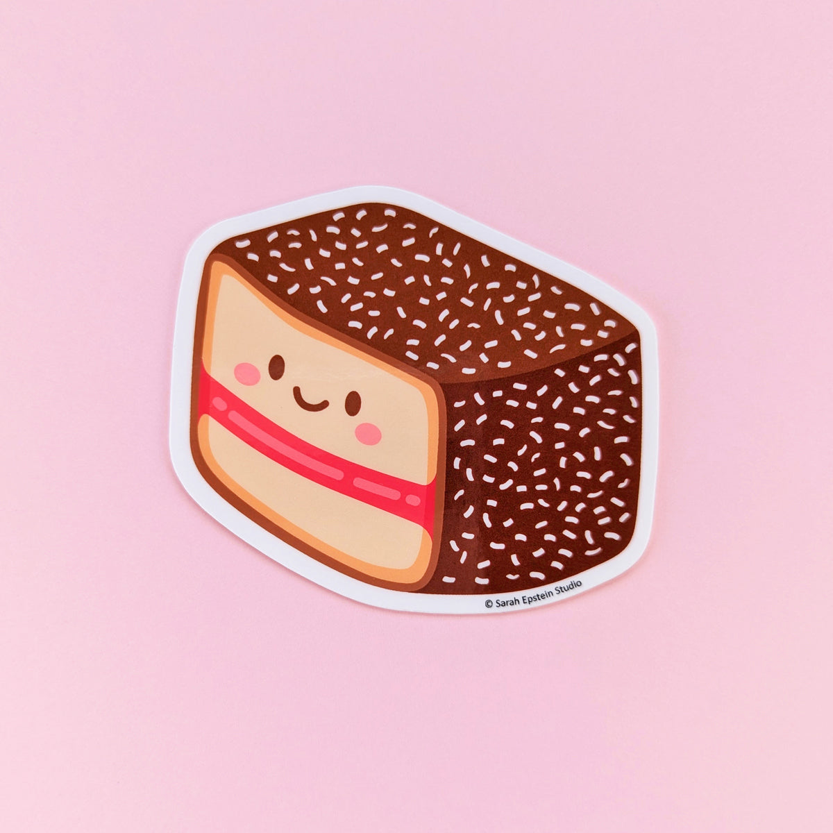 Kawaii lamington die-cut vinyl sticker by Sarah Epstein Studio.