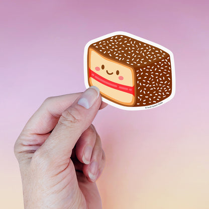 Kawaii lamington die-cut vinyl sticker by Sarah Epstein Studio.